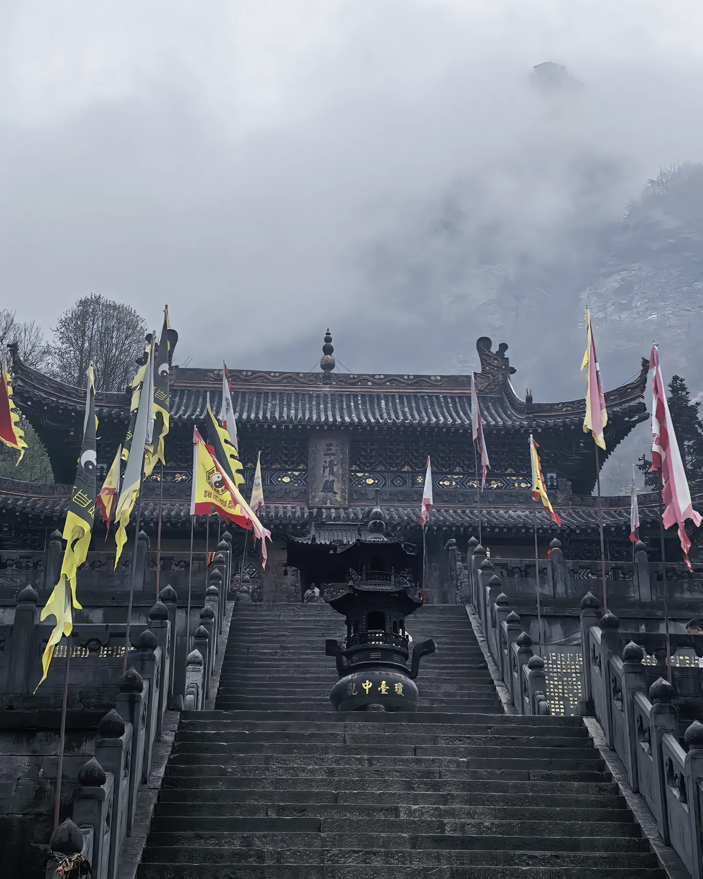 Taoist temple, stone steps and mountain mist
